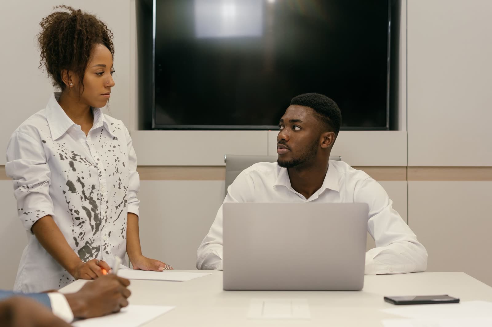 Two business people discussing plans at a laptop